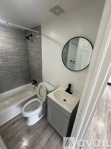 A bathroom with a toilet, sink, and tub.