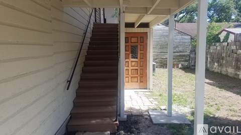 A staircase with a wooden door at the top.
