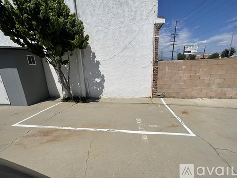 A white line painted on a concrete surface in front of a building.