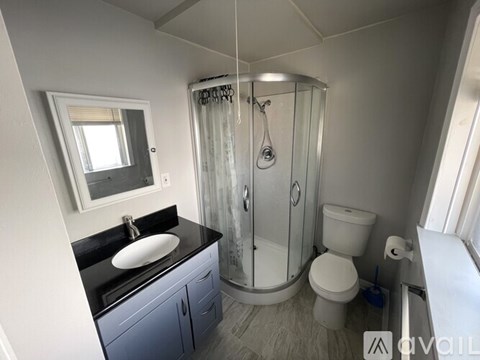A bathroom with a sink, toilet, and shower.