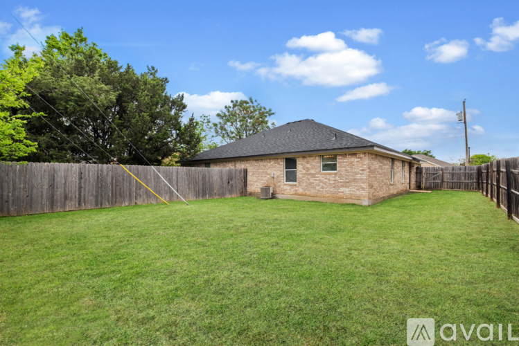 A house with a fence and a green lawn.