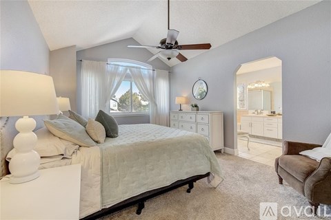 A bedroom with a bed, dresser, and mirror.