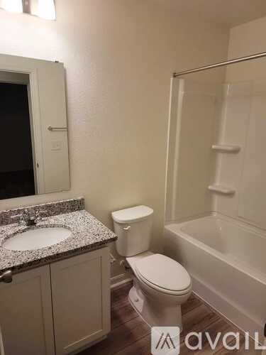 A bathroom with a toilet, sink, and bathtub.