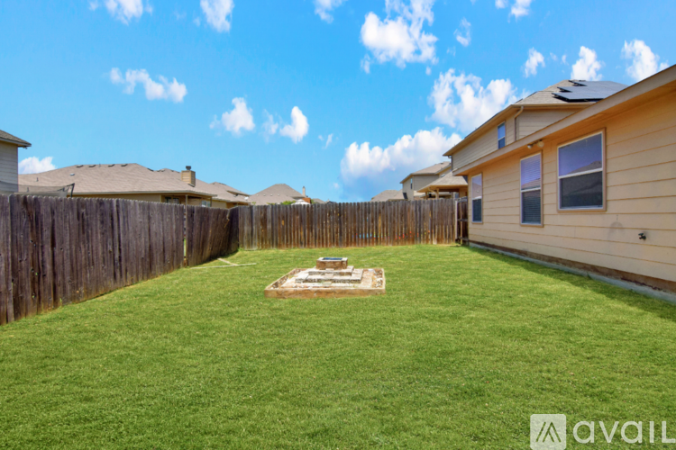 A backyard with a wooden fence and a small garden.