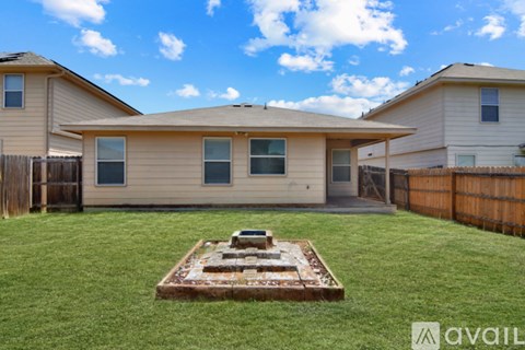 A backyard with a wooden deck and a small garden.