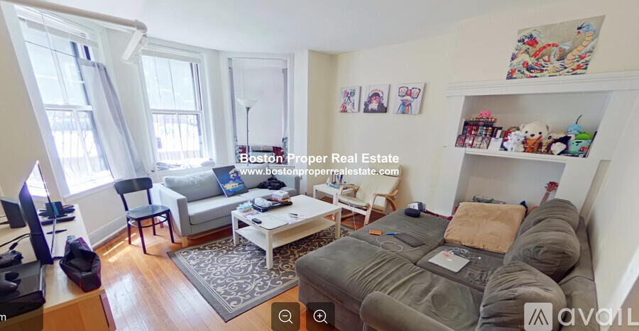 A bedroom with a bed, a couch, a chair, and a table.