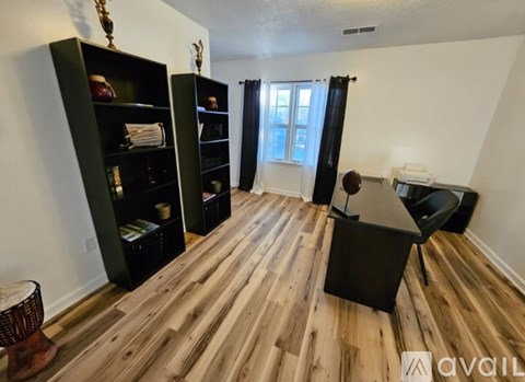 A room with wooden floors and a black table.