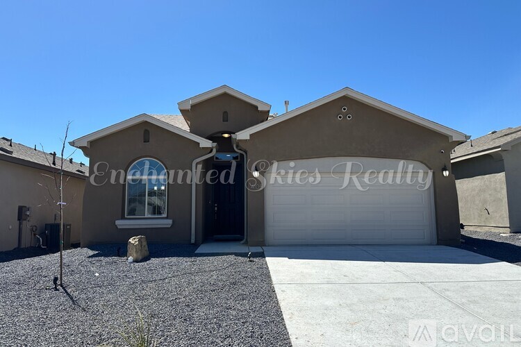 A house with a garage and a driveway in front of it.