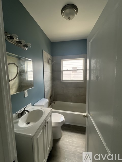 A bathroom with blue walls and a white toilet.