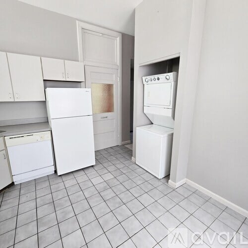 A kitchen with white appliances and cabinets.