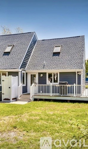 A house with a grey roof and a white porch.
