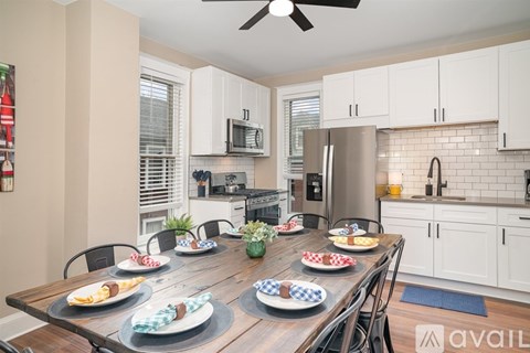 A kitchen with a table set for a meal.