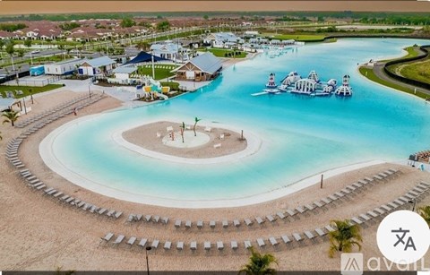 A large swimming pool with a small island in the middle and a water slide.