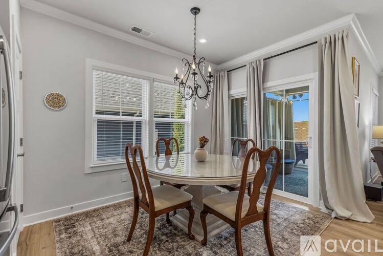 A dining room with a table set for four.