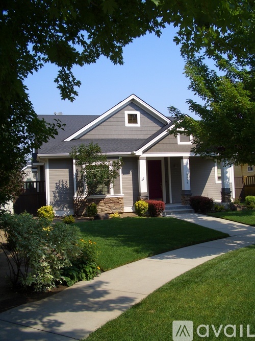 A house with a front yard and a walkway leading to the front door.