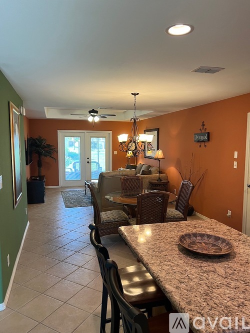 A kitchen with a table and chairs.