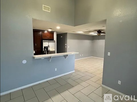 A kitchen area with a counter and a refrigerator.