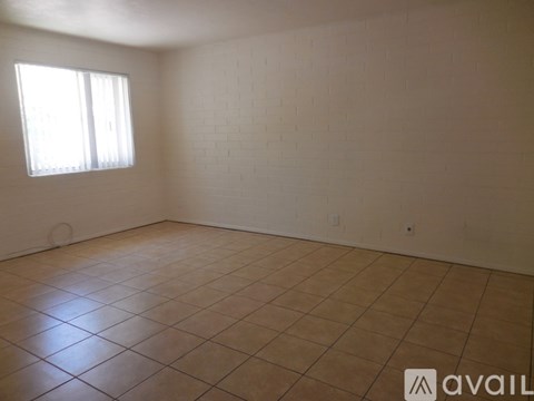 Empty room with tiled floor and white walls.