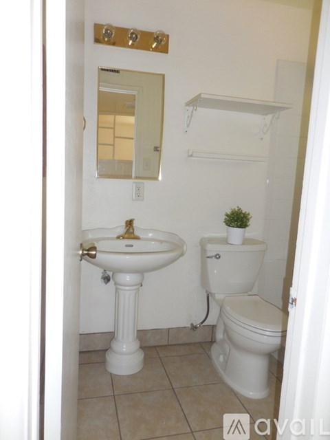 A white sink and toilet in a bathroom.