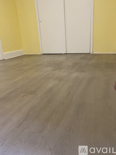 A room with a grey floor and a white door.