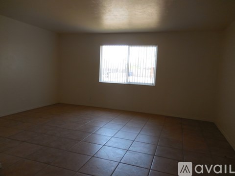 A room with a window and tiled floor.
