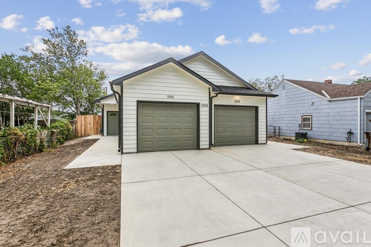 A two-car garage with a white exterior and a grey roof is available for rent.