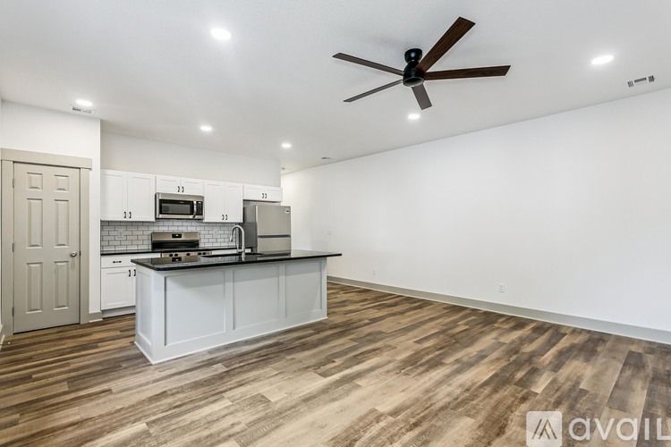 A kitchen with a white countertop and a ceiling fan.