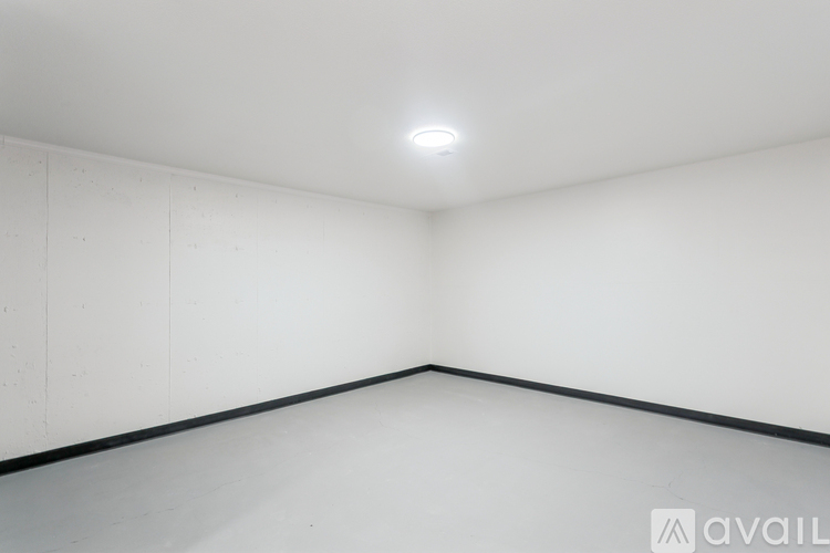 A white room with a black line on the floor.
