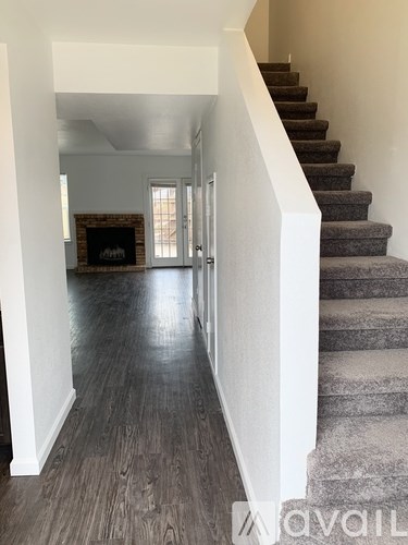 A hallway with a staircase leading to the second floor.