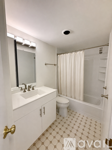 A white bathroom with a sink, toilet, and bathtub.
