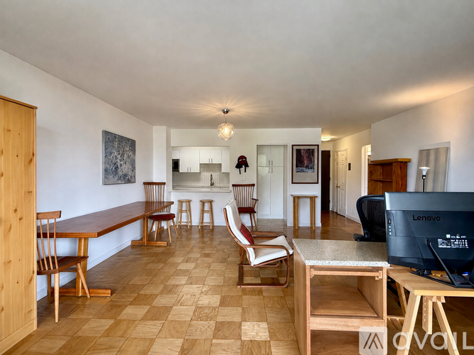 A living room with a checkered floor and a Lenovo computer on a table.