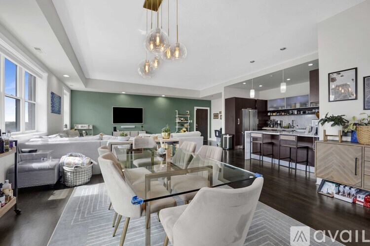 A modern kitchen with a glass dining table and chairs.