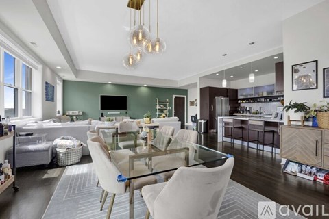 A modern kitchen with a glass dining table and chairs.
