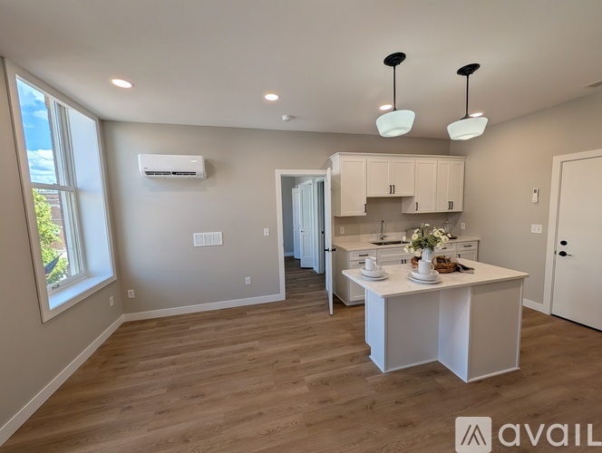 A kitchen area with a table set for two and a window letting in natural light.
