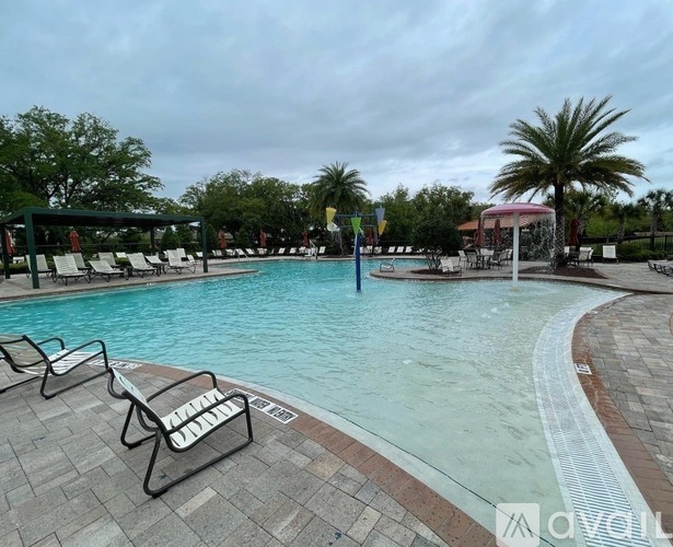 A pool with lounge chairs and a sign that says "NO DIVING".