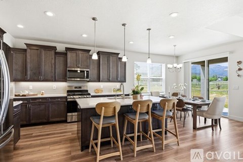 A modern kitchen with wooden cabinets and a central island.