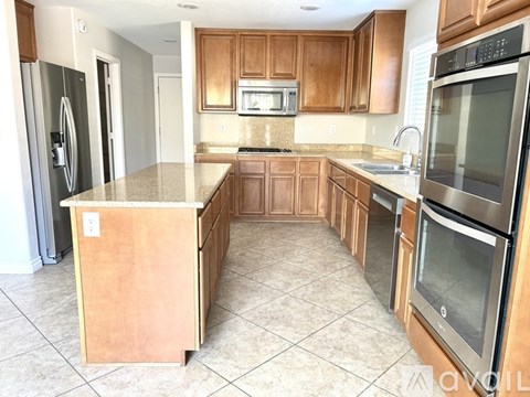 A kitchen with wooden cabinets and stainless steel appliances.