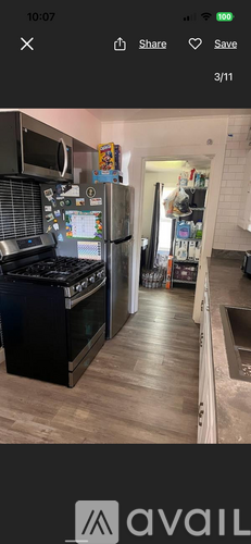 A modern kitchen with a black stove top oven and a silver refrigerator.