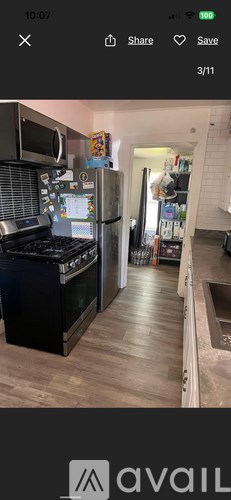A modern kitchen with a black stove top oven and a silver refrigerator.