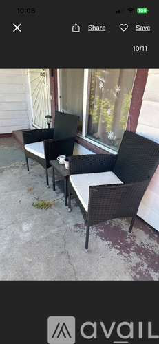 A patio with two chairs and a table.