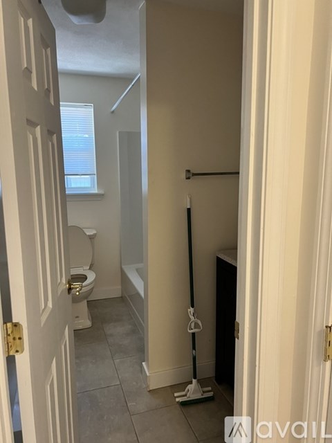 A bathroom with a toilet, sink, and bathtub.