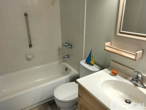 A bathroom with a white toilet, a white sink, and a white bathtub.