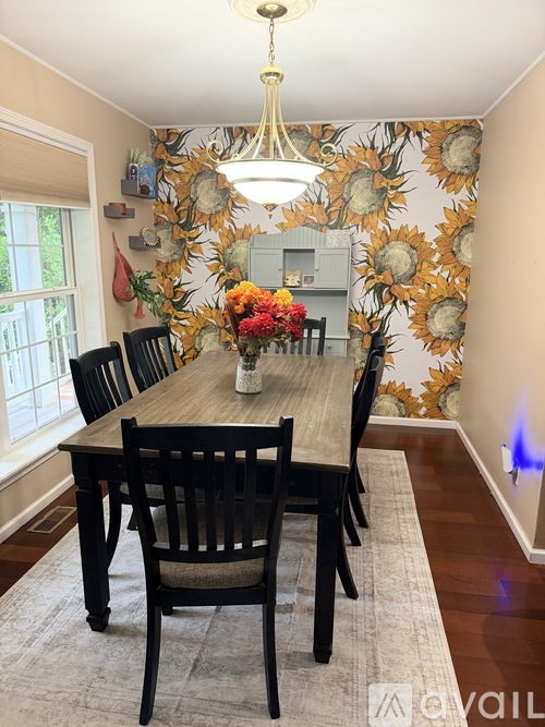 A dining room with a wooden table and chairs.