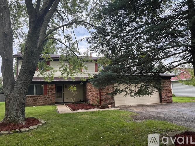 A house with a tree in front of it.