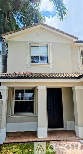 A house with a black door and a window.