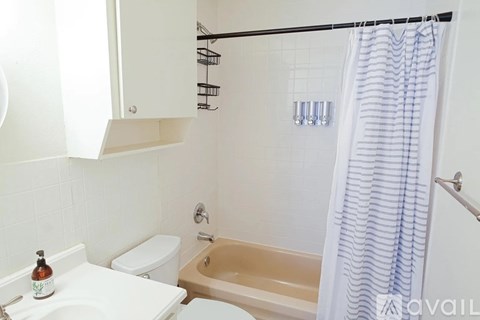 A white toilet sits next to a sink in a bathroom.