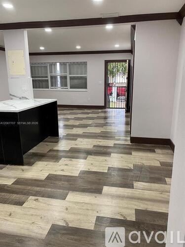 A hallway with a black reception desk and a checkered floor.