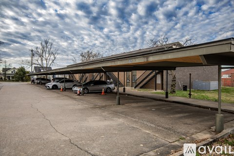 A parking lot with cars and a building in the background.