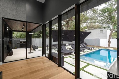A modern house with a pool in the backyard.