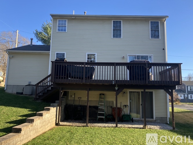 A two-story house with a balcony and a garage.